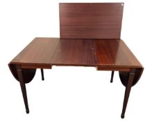 A Scandinavian teak effect extending dining table.