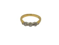 An 18ct gold three stone diamond ring, size K1/2 CONDITION REPORT: 3.