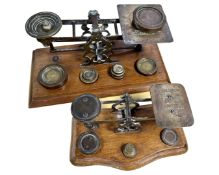 Two sets of antique brass postal scales, with weights.