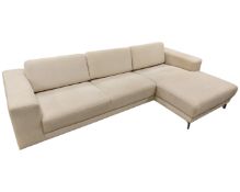 A contemporary L-shaped corner settee upholstered in oatmeal fabric.