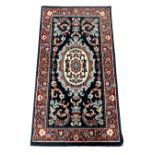 A small eastern woolen rug 106 cm x 60 cm