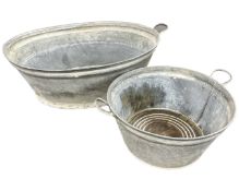 Two galvanized twin handled metal tubs (largest 81 cm wide)