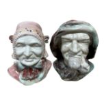 A pair of early 20th century glazed pottery busts depicting a man smoking a pipe and a lady with