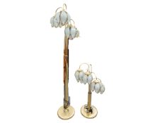 Two brass floor lamps with glass flower shades.