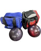 Two bowling balls in carry cases.