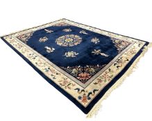 A Chinese carpet on indigo ground 274 cm x 370 cm