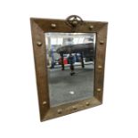 An Arts and Crafts brass framed mirror