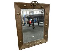 An Arts and Crafts brass framed mirror