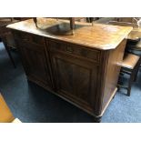 A 19th century mahogany double door sideboard fitted with two drawers above on bun feet.