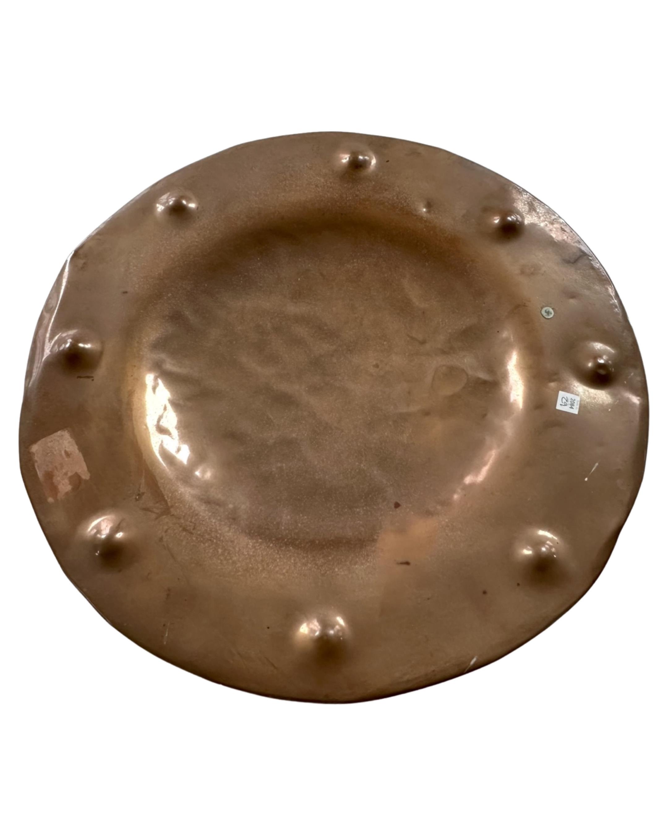 A hammered copper charger.