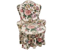 A floral upholstered lady's chair.