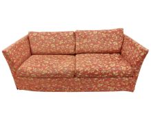 A late 20th century three seater settee in floral upholstery.