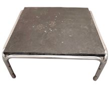 A slate and metal framed square coffee table.