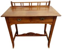 An Edwardian mahogany side table fitted with two drawers.