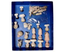 A collection of antique china miniature doll's heads and parts.