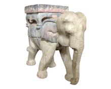 A carved wooden elephant plant stand.