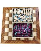 A wooden chessboard together with Chinese resin chess pieces.
