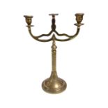 An antique brass three way candelabrum.