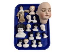 A tray containing a collection of antique china doll's heads.