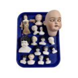 A tray containing a collection of antique china doll's heads.