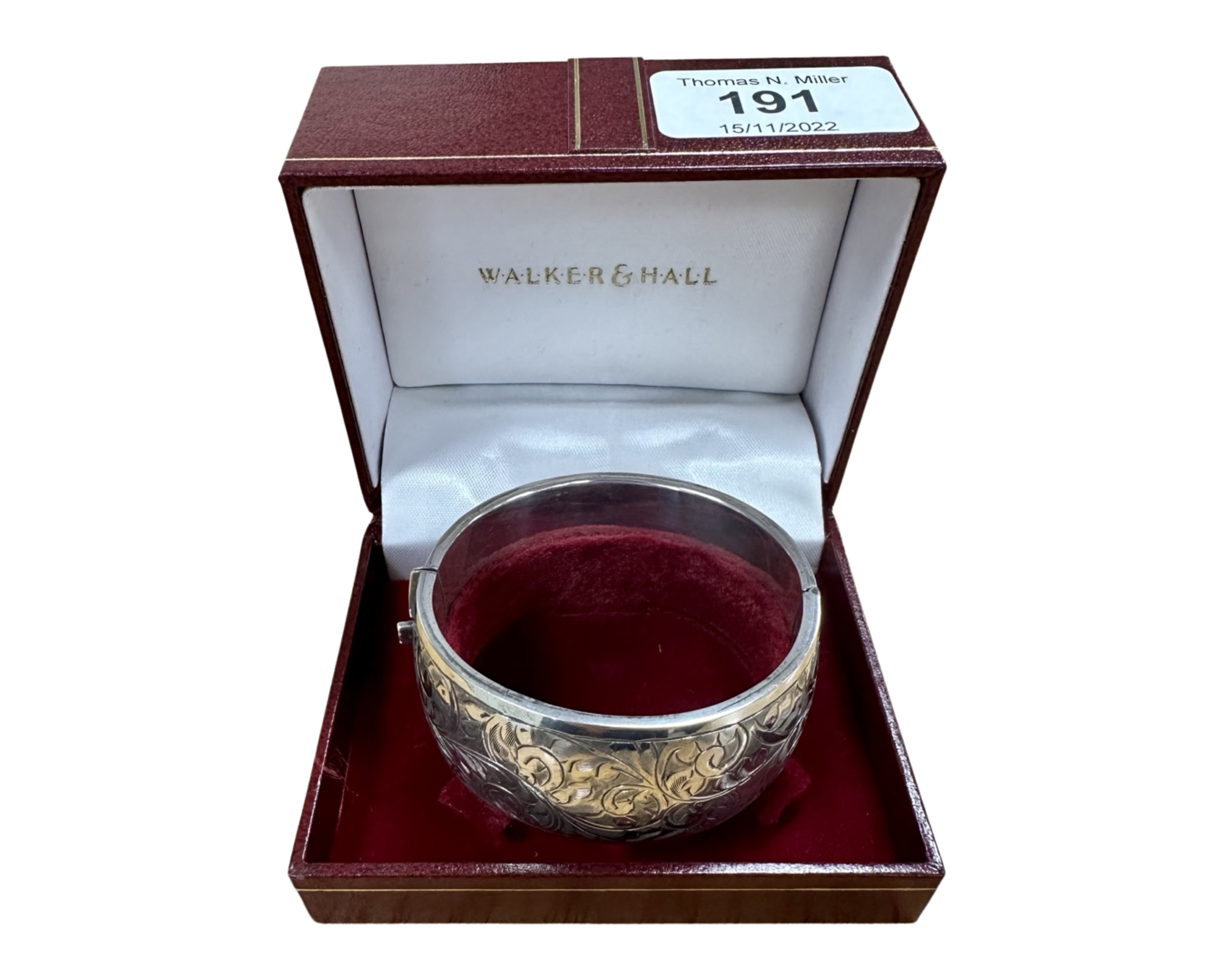 An engraved silver bangle in Walker & Hall box.