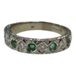 An 18ct white gold emerald and diamond half-eternity ring, size P, 5.2g.