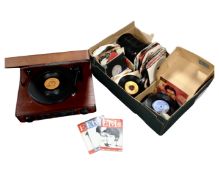A record player together with a box containing a quantity of mid-20th century and later 7' vinyl
