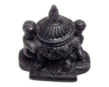 A 19th century cast metal miniature inkwell.