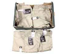 A box containing Dickies flat front work pants.