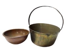 A brass cast iron handle jam pan together with a copper bowl.