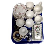 A tray containing Duchess June Bouquet tea china, Portmeirion Botanic Gardens milk jug,