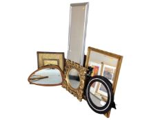 Five assorted framed mirrors together with a brass embossed panel.