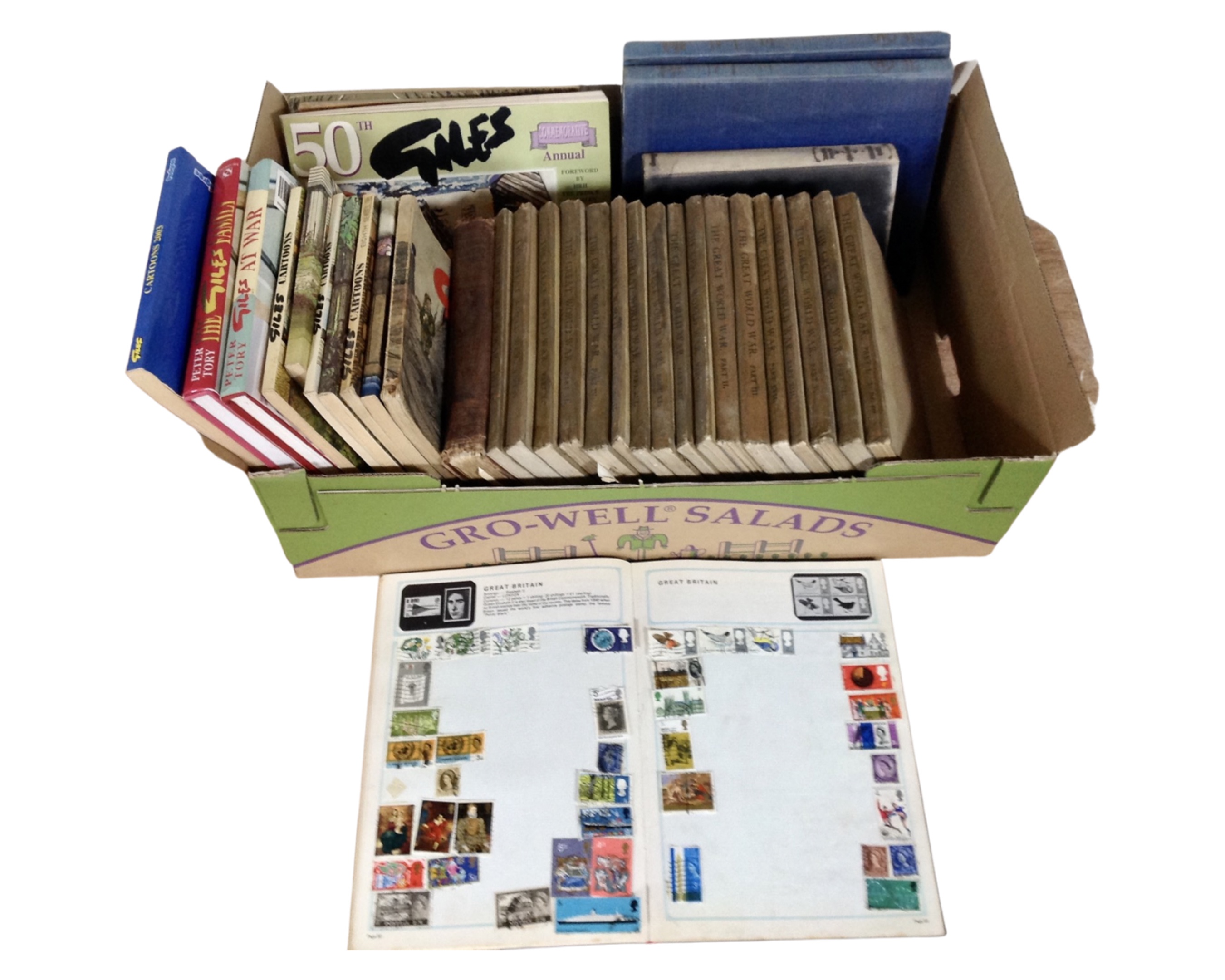 A box containing 17 volumes of The Great War, Giles cartoon books, a stamp album with stamps etc.