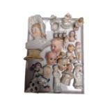 A tray containing a collection of antique china doll's heads and figurines.