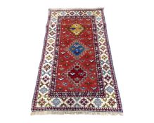 A Caucasian design woolen rug,