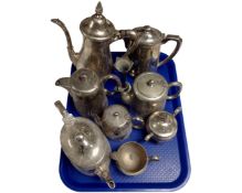 A tray containing assorted plated tea ware together with a bud vase.