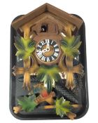 A cuckoo clock with pendulum and weights.