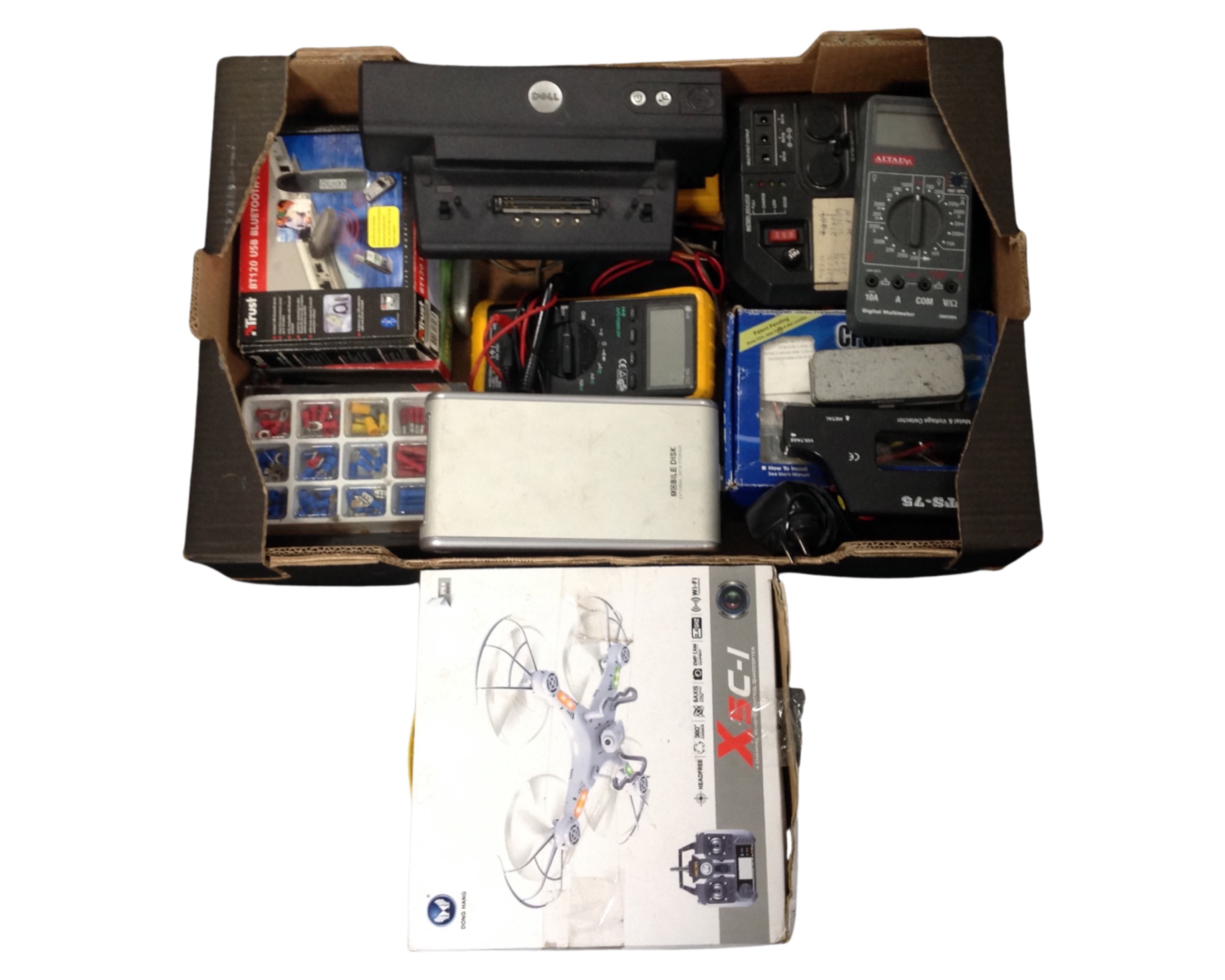 A box containing a remote control quad copter (boxed), digital meters, a portable power station,