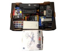 A box containing a remote control quad copter (boxed), digital meters, a portable power station,