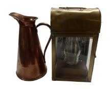 An antique copper jug together with an antique brass cased oil lamp.
