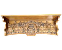 An Edwardian carved five peg coat rack with shelf