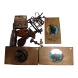 A tray containing antique keys, vintage tins, a 19th century door knocker in the form of a hand,