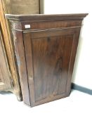 A 19th century mahogany panel door hanging corner cabinet