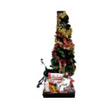 A 5' Christmas tree with tinsel together with a metal Christmas tree stand a box containing