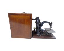 A 19th century Wilcox and Gibbs sewing machine in mahogany case
