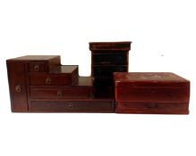 A stepped multi drawer chest together with an antique pine three drawer miniature chest and a