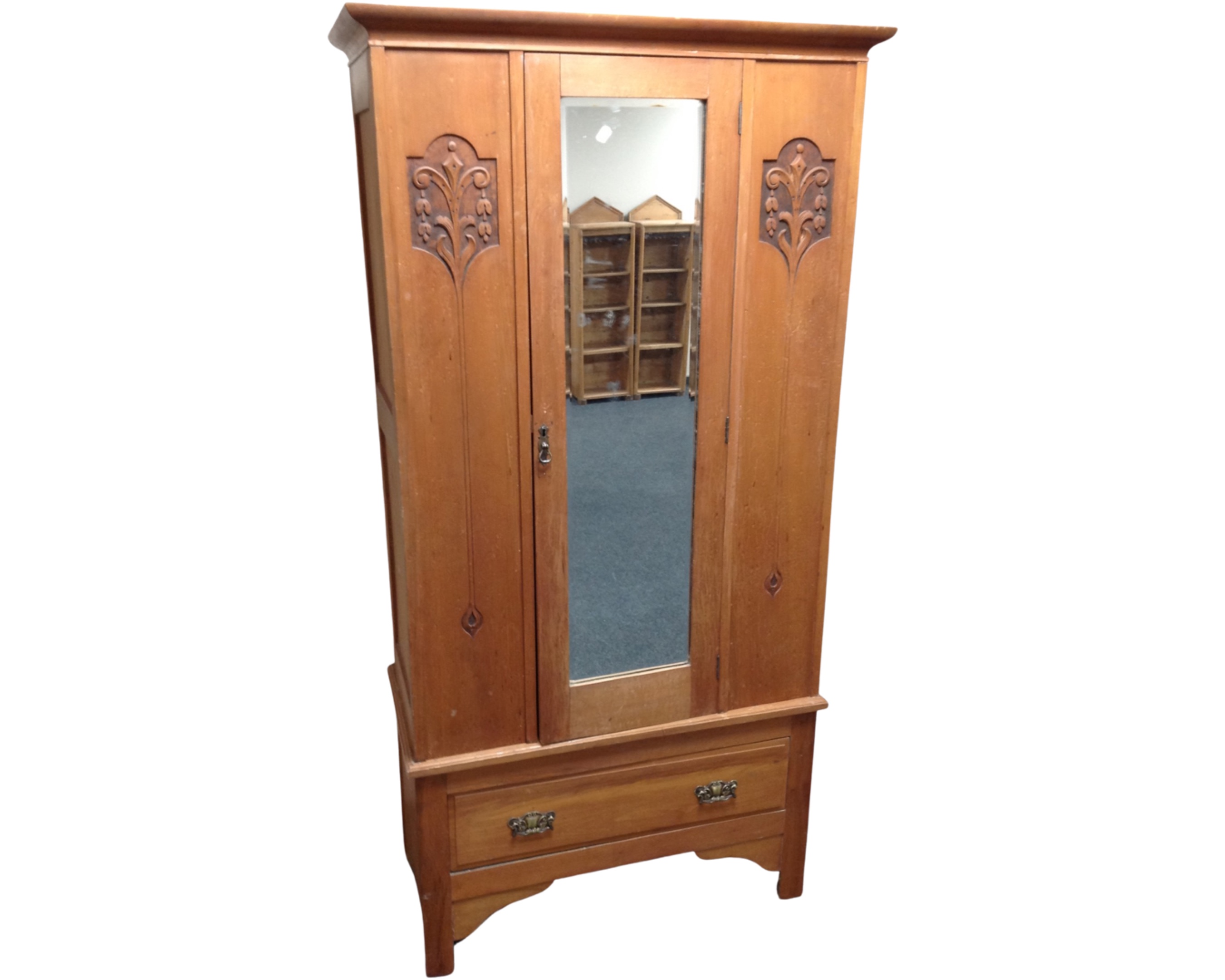 A satinwood Arts & Crafts mirror door wardrobe fitted with a drawer