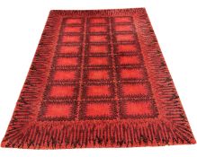 A contemporary carpet on red ground, 170cm by 230cm.