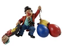 A hanging ornament of a clown with balloons.