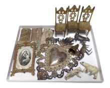 A tray containing metalware including white metal embossed plaques, lead animal figures,